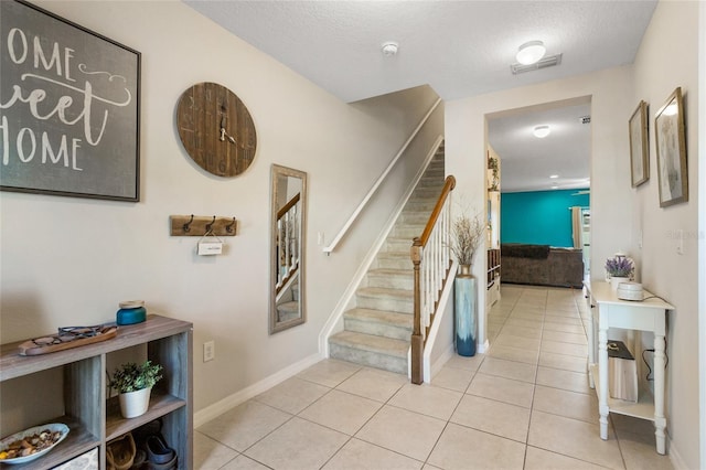 281 Primrose Dr, Davenport, FL 33837 - staircase featuring tile patterned floors, baseboards, and a textured ceiling