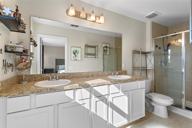 281 Primrose Dr, Davenport, FL 33837 - full bathroom featuring a stall shower, tile patterned flooring, double vanity, and toilet