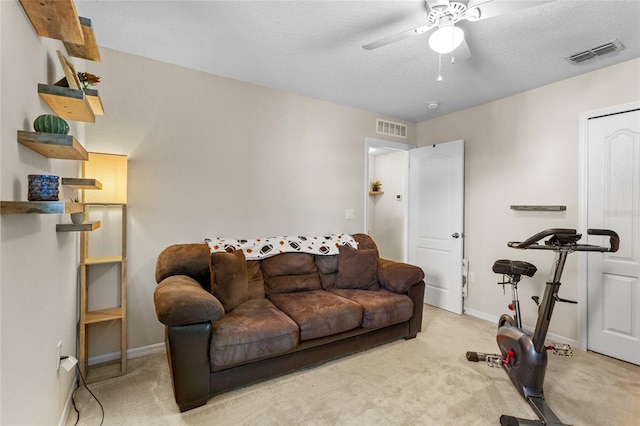281 Primrose Dr, Davenport, FL 33837 - living area with carpet, a ceiling fan, baseboards, and a textured ceiling