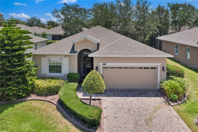 3677 Serena Ln, Clermont, FL 34711 - ranch-style home featuring a shingled roof, stucco siding, an attached garage, decorative driveway, and a front yard