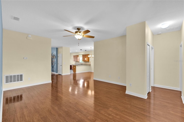 3677 Serena Ln, Clermont, FL 34711 - unfurnished living room with ceiling fan, wood finished floors, and baseboards
