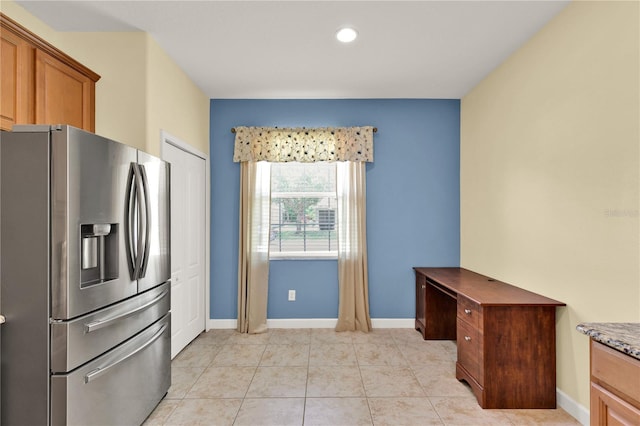 3677 Serena Ln, Clermont, FL 34711 - kitchen with stainless steel fridge with ice dispenser, baseboards, brown cabinets, light tile patterned flooring, and recessed lighting