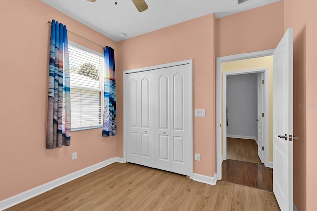 3677 Serena Ln, Clermont, FL 34711 - unfurnished bedroom featuring light wood-style floors, a closet, baseboards, and a ceiling fan