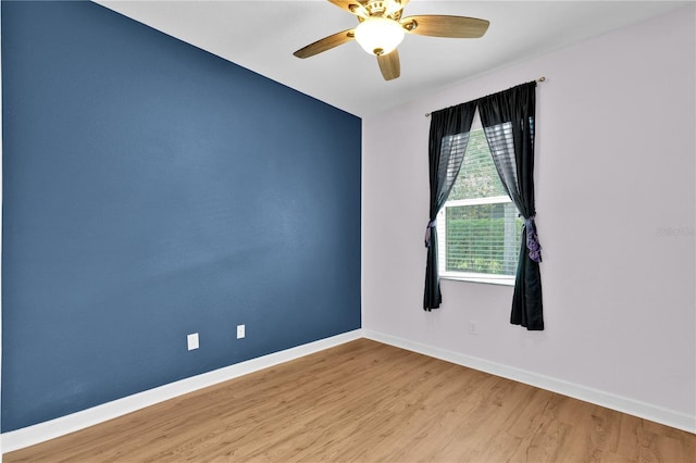 3677 Serena Ln, Clermont, FL 34711 - unfurnished room with baseboards, wood finished floors, and a ceiling fan