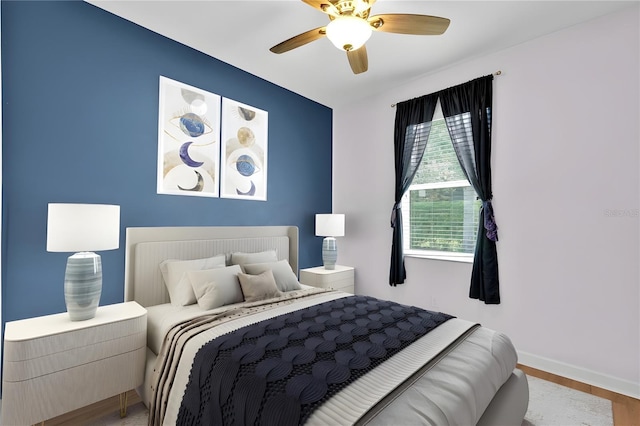 3677 Serena Ln, Clermont, FL 34711 - bedroom with baseboards, ceiling fan, and wood finished floors