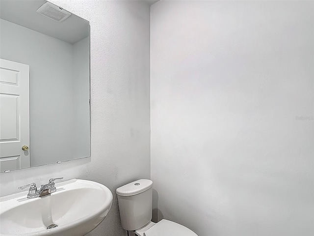 bathroom featuring a sink and toilet