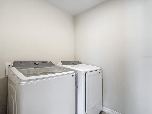laundry room with washing machine and clothes dryer