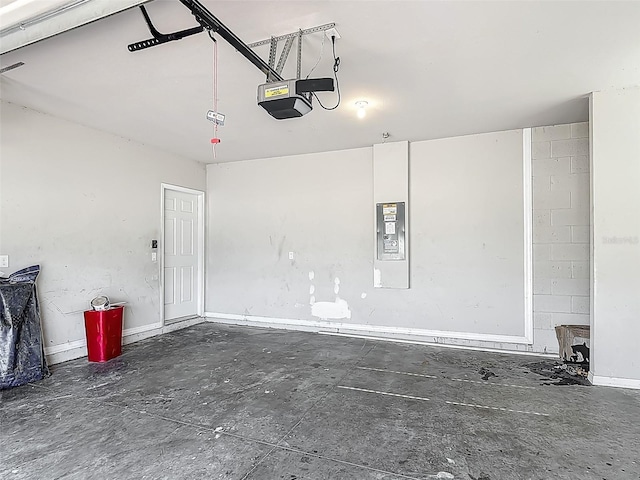 garage with a garage door opener and electric panel