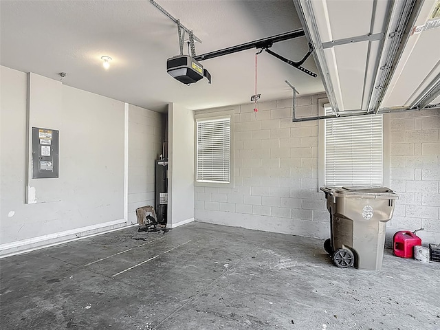 garage featuring electric panel, a garage door opener, and concrete block wall