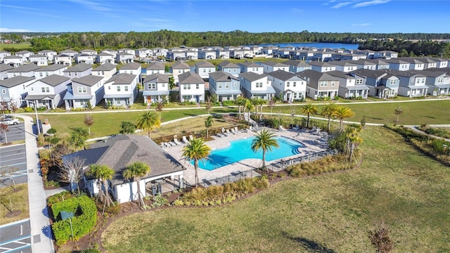 aerial perspective of suburban area featuring a pool