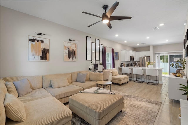 146 E 15th St, Apopka, FL 32703 - living area featuring a ceiling fan, recessed lighting, and light wood-type flooring