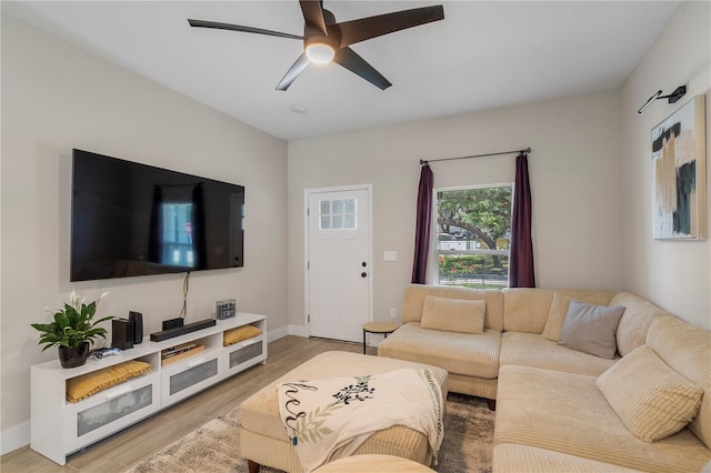 146 E 15th St, Apopka, FL 32703 - living room featuring a ceiling fan, light wood-style flooring, and baseboards