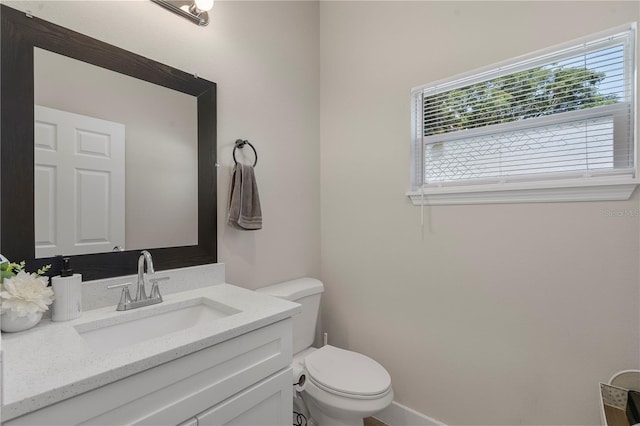 146 E 15th St, Apopka, FL 32703 - bathroom with toilet, vanity, and baseboards