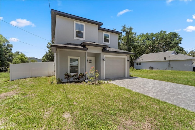 146 E 15th St, Apopka, FL 32703 - view of front facade with stucco siding, decorative driveway, and an attached garage