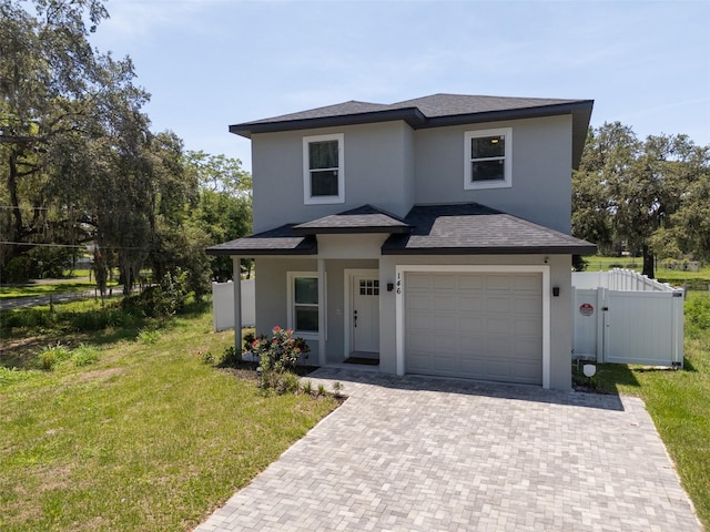 146 E 15th St, Apopka, FL 32703 - view of front of house featuring stucco siding, decorative driveway, an attached garage, and roof with shingles