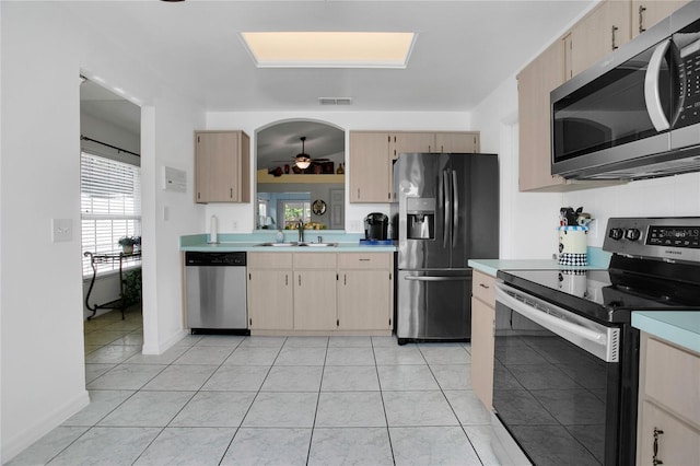 204 Bay Meadow Dr, Kissimmee, FL 34746 - kitchen with stainless steel appliances, light countertops, ceiling fan, a sink, and light tile patterned flooring