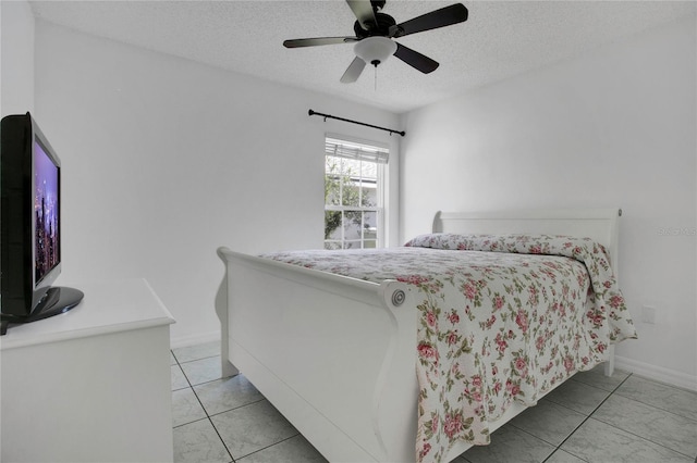 204 Bay Meadow Dr, Kissimmee, FL 34746 - bedroom featuring a textured ceiling, light tile patterned floors, a ceiling fan, and baseboards