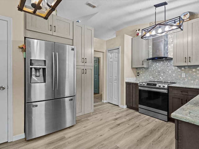 1112 Winding Water Way, Clermont, FL 34714 - kitchen with appliances with stainless steel finishes, wall chimney exhaust hood, light wood finished floors, and light stone countertops