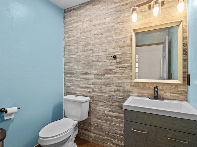 1112 Winding Water Way, Clermont, FL 34714 - half bathroom featuring toilet, vanity, and tile walls