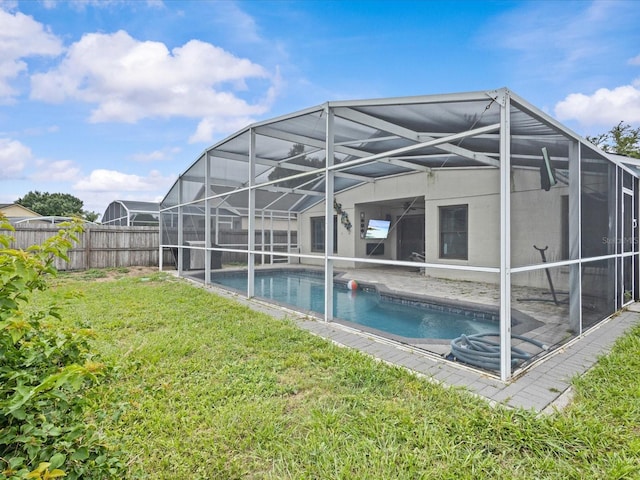 1112 Winding Water Way, Clermont, FL 34714 - back of property featuring glass enclosure and a patio area
