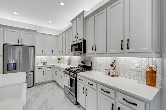 kitchen with appliances with stainless steel finishes, light countertops, recessed lighting, decorative backsplash, and light marble finish flooring