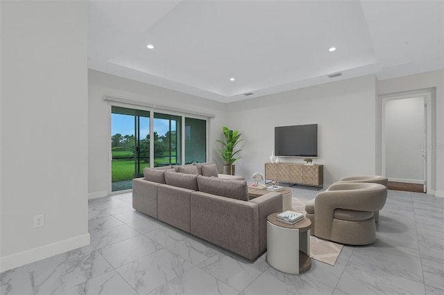 living room with a raised ceiling, baseboards, light marble finish floors, and recessed lighting