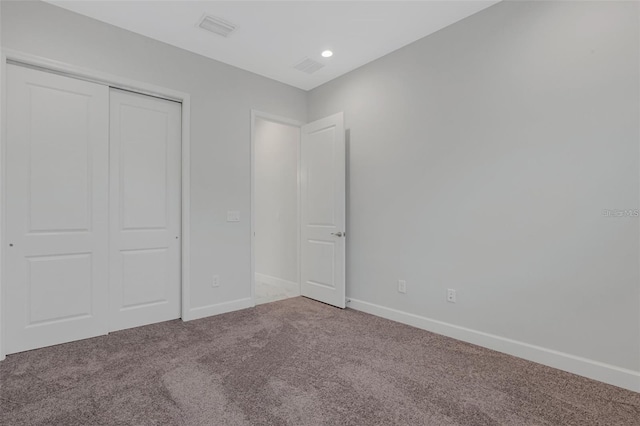 unfurnished bedroom with carpet, baseboards, a closet, and recessed lighting