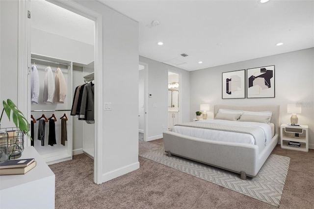 bedroom with carpet floors, recessed lighting, baseboards, a walk in closet, and a closet