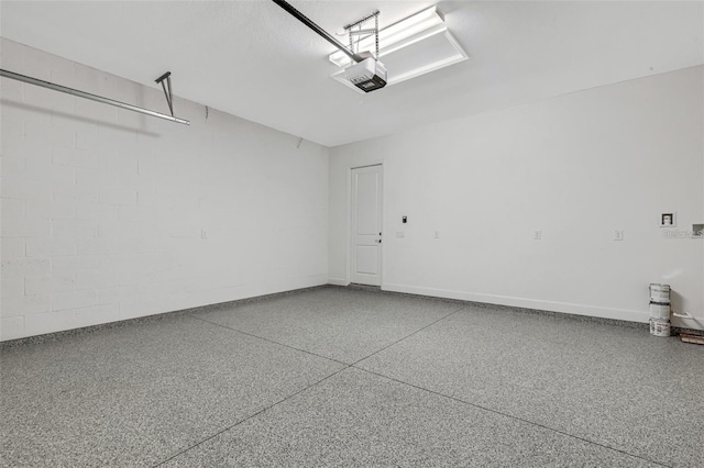 garage featuring a garage door opener and baseboards