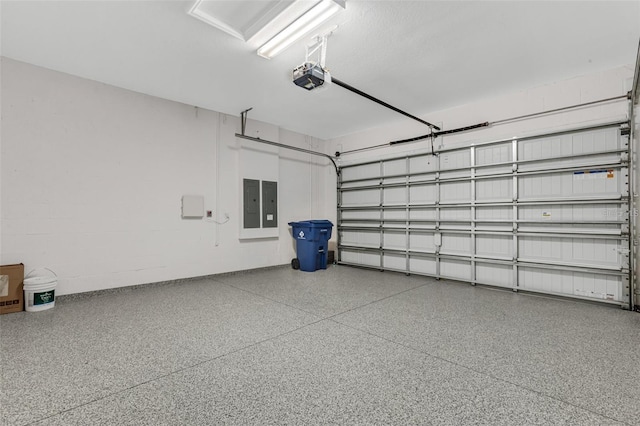 garage with a garage door opener and electric panel