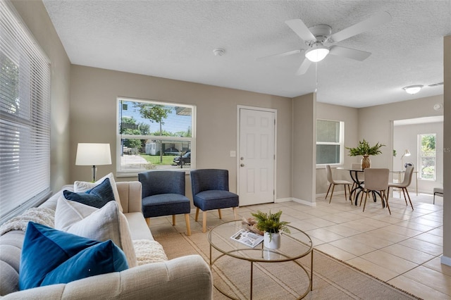 614 Plum Ln, Altamonte Springs, FL 32701 - living room featuring light tile patterned flooring, a textured ceiling, a ceiling fan, and baseboards