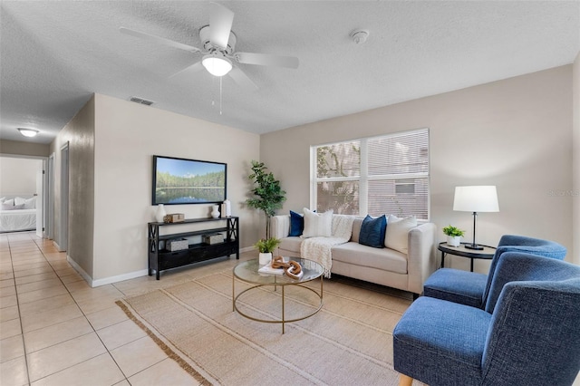 614 Plum Ln, Altamonte Springs, FL 32701 - living room with light tile patterned floors, a textured ceiling, ceiling fan, and baseboards