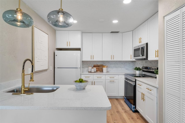 614 Plum Ln, Altamonte Springs, FL 32701 - kitchen with stainless steel appliances, a sink, white cabinets, and recessed lighting