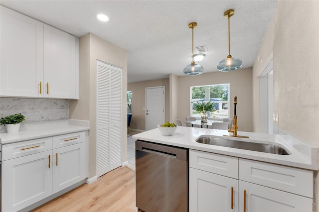 614 Plum Ln, Altamonte Springs, FL 32701 - kitchen featuring stainless steel dishwasher, a sink, white cabinetry, pendant lighting, and light wood-style flooring