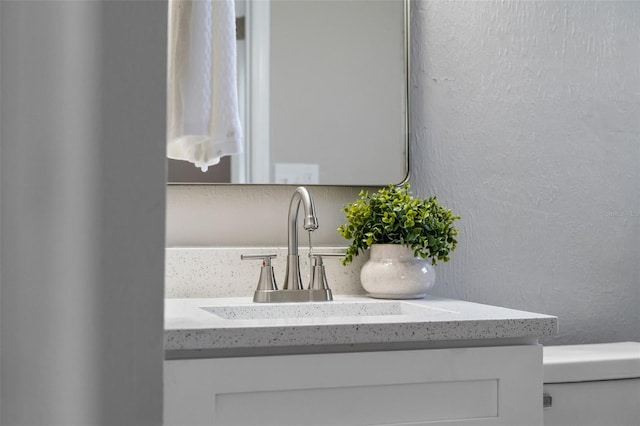 614 Plum Ln, Altamonte Springs, FL 32701 - bathroom view of vanity, a textured wall, and toilet