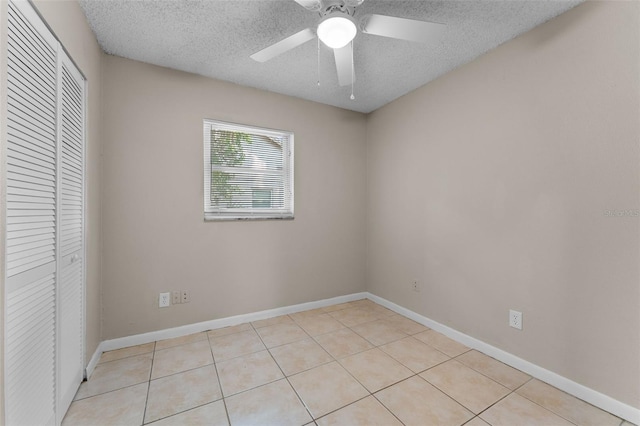614 Plum Ln, Altamonte Springs, FL 32701 - unfurnished bedroom with a closet, a textured ceiling, light tile patterned flooring, a ceiling fan, and baseboards