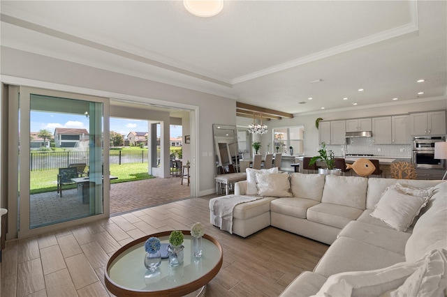 10529 Royal Cypress Way, Orlando, FL 32836 - living room with a chandelier, ornamental molding, recessed lighting, light wood-style flooring, and a water view