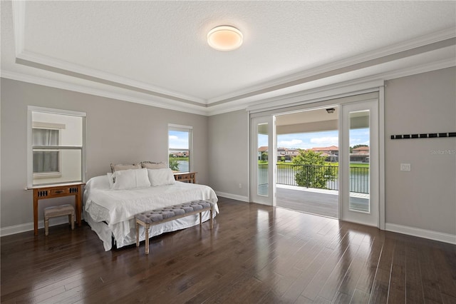 10529 Royal Cypress Way, Orlando, FL 32836 - bedroom with access to outside, a tray ceiling, crown molding, wood finished floors, and a water view
