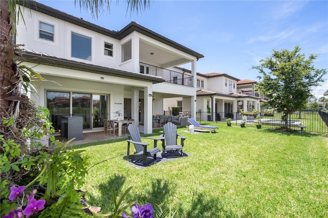 10529 Royal Cypress Way, Orlando, FL 32836 - rear view of house featuring a balcony, stucco siding, and a patio area