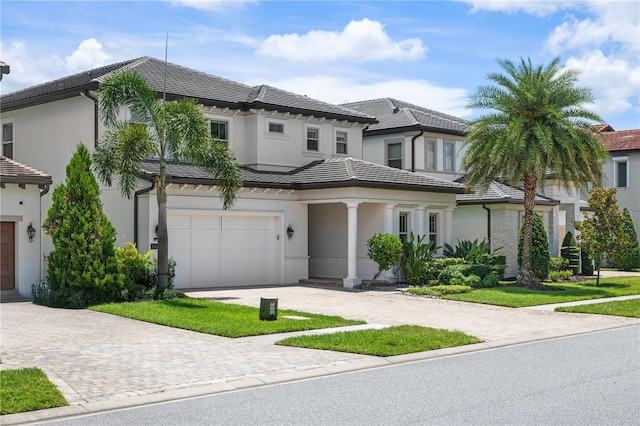 10529 Royal Cypress Way, Orlando, FL 32836 - view of front facade with decorative driveway, a garage, stucco siding, and a tiled roof