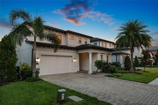 10529 Royal Cypress Way, Orlando, FL 32836 - view of front of house with decorative driveway, a front lawn, stucco siding, and an attached garage