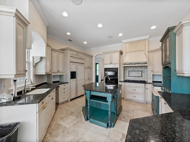 6161 Blakeford Dr, Windermere, FL 34786 - kitchen with paneled fridge, backsplash, dishwasher, dark stone counters, and crown molding