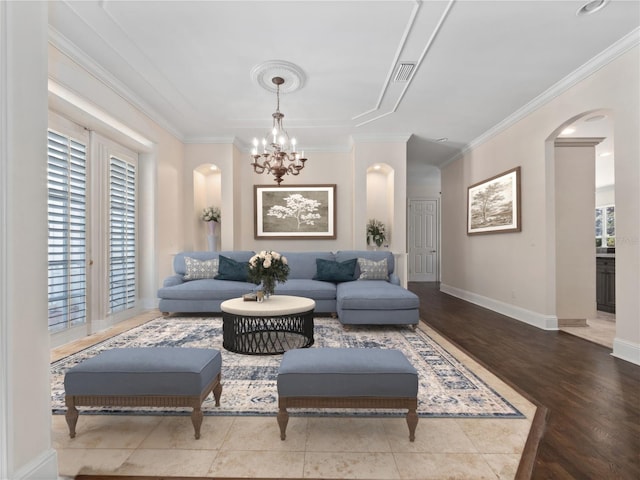 6161 Blakeford Dr, Windermere, FL 34786 - living area with arched walkways, ornamental molding, a chandelier, and wood finished floors