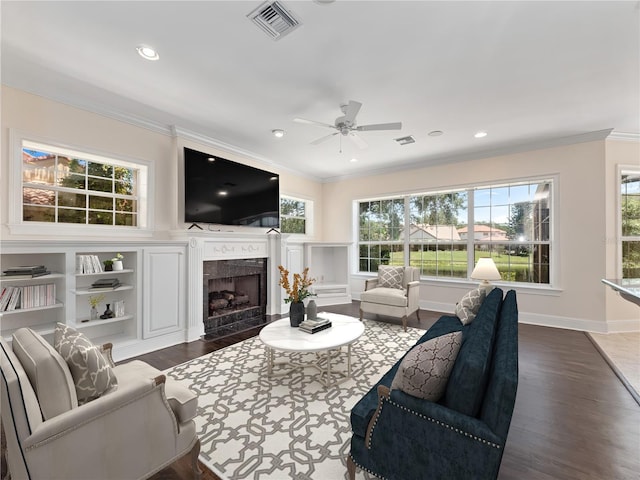 6161 Blakeford Dr, Windermere, FL 34786 - living room featuring crown molding, healthy amount of natural light, dark wood-style flooring, a ceiling fan, and a fireplace with flush hearth