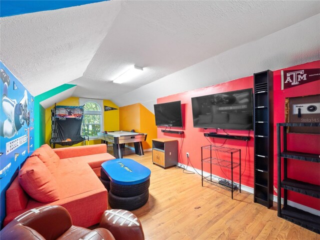 6161 Blakeford Dr, Windermere, FL 34786 - recreation room with a textured ceiling, wood finished floors, and lofted ceiling