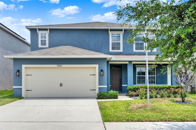 5967 Churchill Square Way, Groveland, FL 34736 - traditional home featuring stucco siding, driveway, an attached garage, a front yard, and a shingled roof