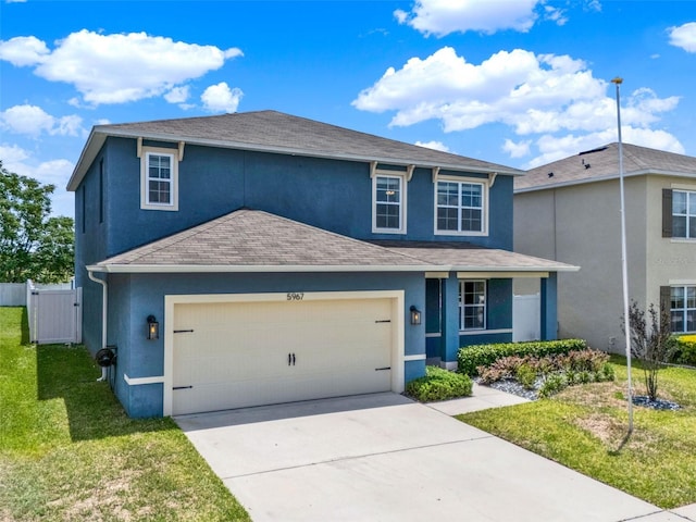 5967 Churchill Square Way, Groveland, FL 34736 - traditional-style home with stucco siding, concrete driveway, a shingled roof, a garage, and a gate
