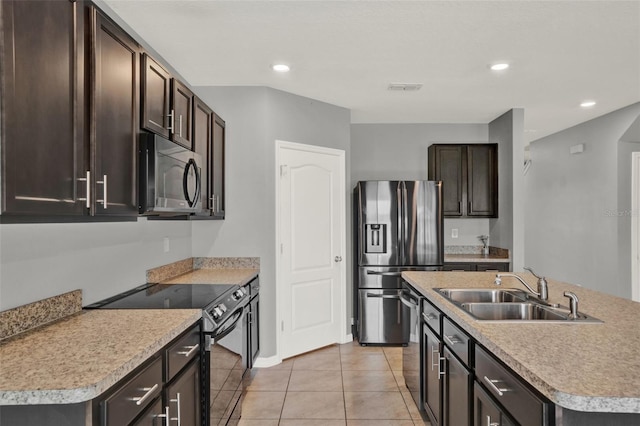 5967 Churchill Square Way, Groveland, FL 34736 - kitchen with stainless steel appliances, a sink, dark brown cabinetry, light countertops, and light tile patterned floors