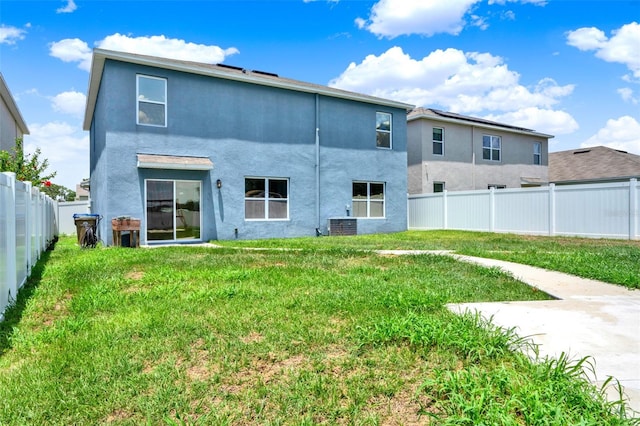 5967 Churchill Square Way, Groveland, FL 34736 - rear view of house with stucco siding and central AC