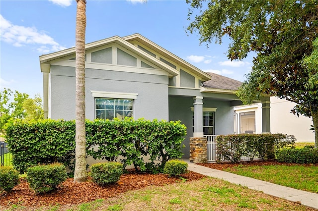 2125 Shackley Pl, Apopka, FL 32703 - view of front facade with stucco siding, a porch, and roof with shingles